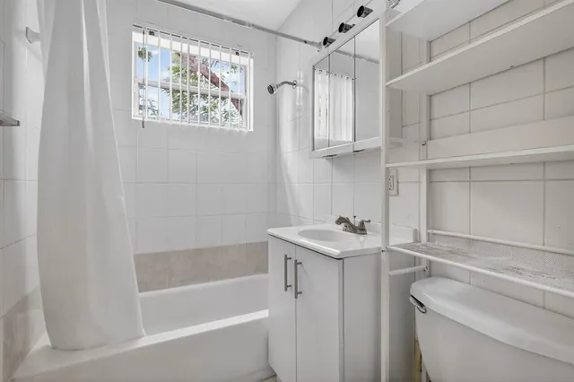 a bathroom with a sink a toilet and bathtub