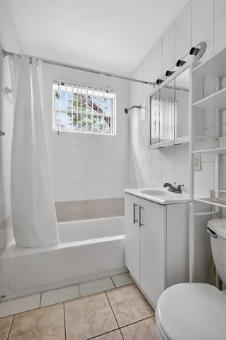 a bathroom with a sink a toilet and bathtub