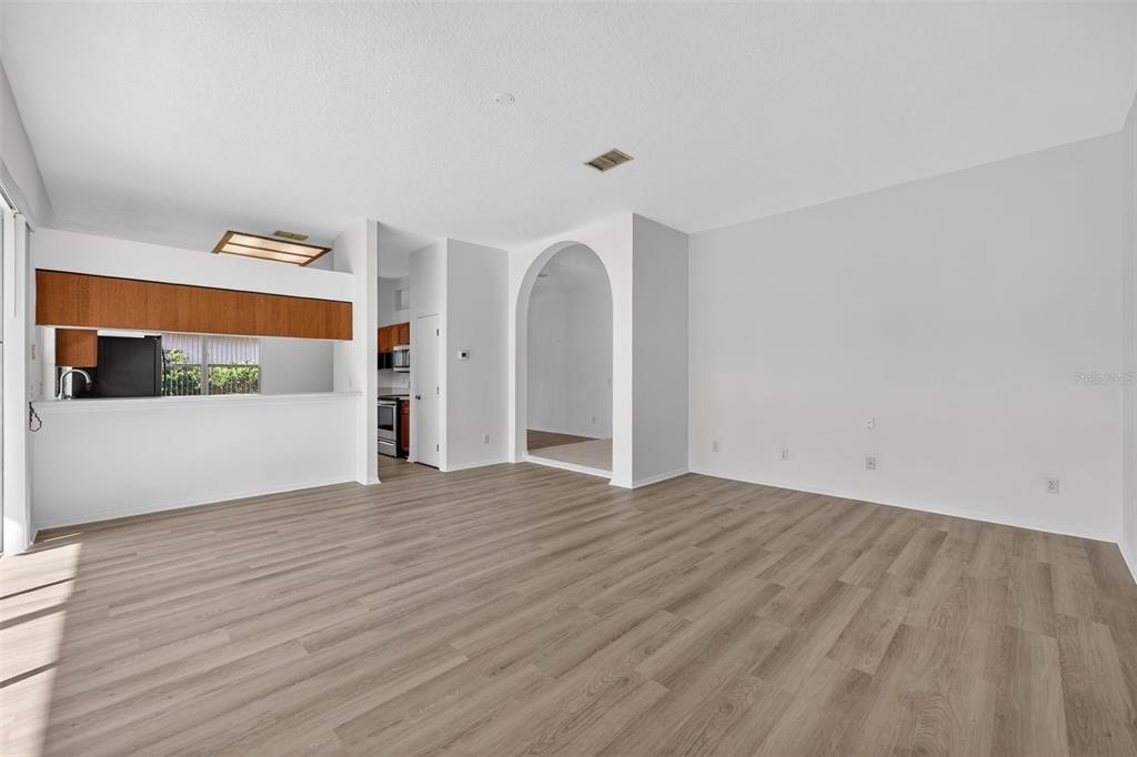 28244 Brokenmead Path Wesley Chapel, FL 33543 - Photo 14 of 37 a view of an empty room with wooden floor and a window