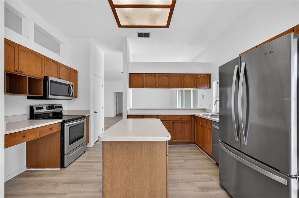 28244 Brokenmead Path Wesley Chapel, FL 33543 - Photo 16 of 37 a kitchen with stainless steel appliances granite countertop a refrigerator a stove top oven a sink and dishwasher