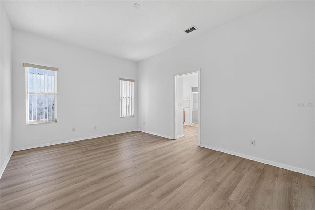 28244 Brokenmead Path Wesley Chapel, FL 33543 - Photo 19 of 37 a view of an empty room with wooden floor and a window