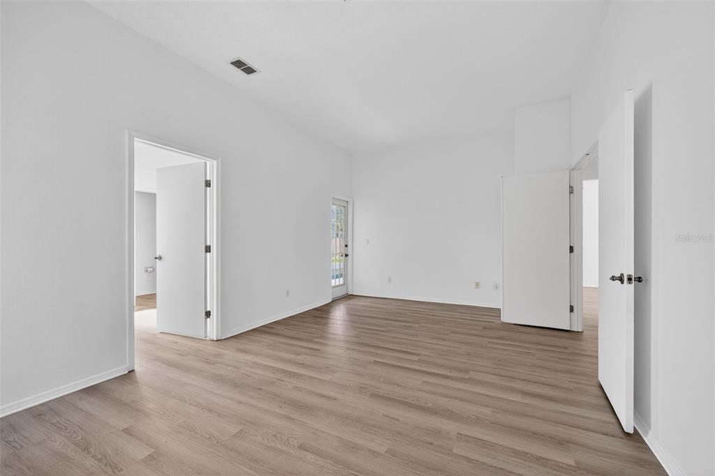 28244 Brokenmead Path Wesley Chapel, FL 33543 - Photo 21 of 37 a view of an empty room with wooden floor