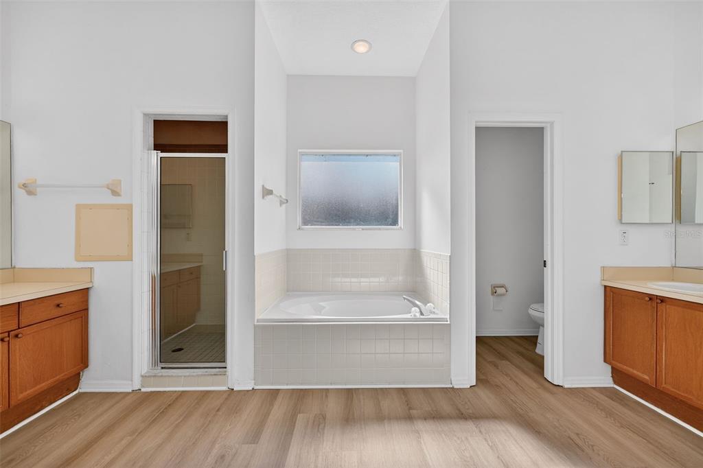 28244 Brokenmead Path Wesley Chapel, FL 33543 - Photo 22 of 37 a view of a hallway with wooden floor and cabinet