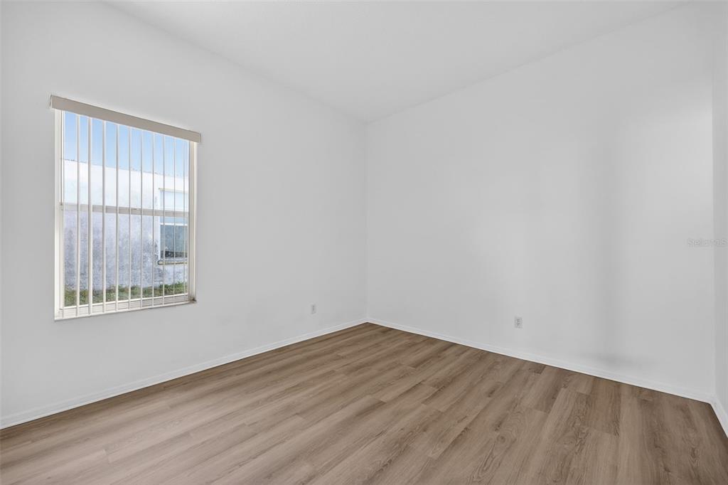 28244 Brokenmead Path Wesley Chapel, FL 33543 - Photo 26 of 37 wooden floor in an empty room with a window