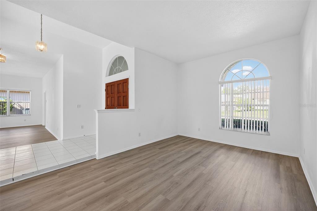 28244 Brokenmead Path Wesley Chapel, FL 33543 - Photo 7 of 37 a view of empty room with wooden floor and fan