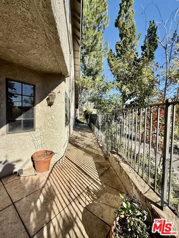 a kitchen with stainless steel appliances granite countertop a refrigerator a stove top oven a sink dishwasher and white cabinets with wooden floor