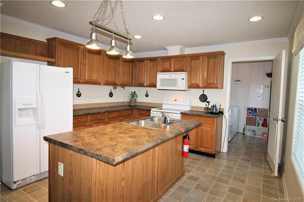 205 Sikes Mill Road Monroe, NC 28110 - Photo 14 of 37 a kitchen with stainless steel appliances granite countertop a sink a stove and a refrigerator