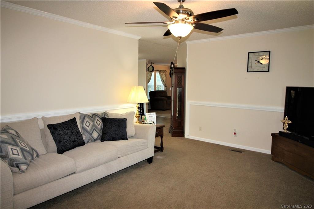 205 Sikes Mill Road Monroe, NC 28110 - Photo 8 of 37 a living room with furniture and a flat screen tv