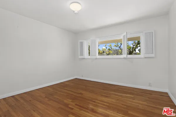 a view of room with wooden floor and window