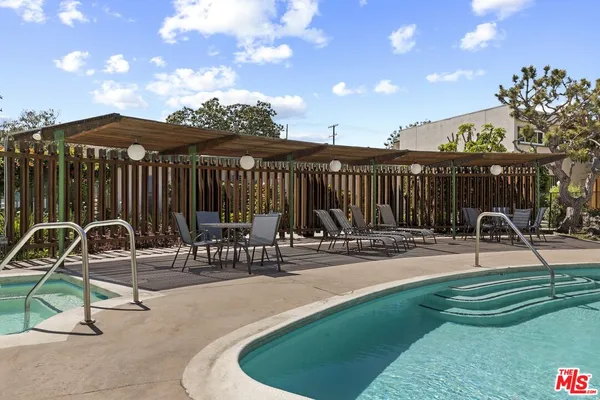 a view of a swimming pool with a patio and a garden