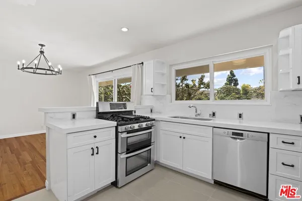 a kitchen that has a sink and a stove