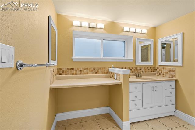 807 Fontmore Road Colorado Springs, CO 80904 - Photo 50 of 50 Bathroom with tile flooring, backsplash, and vanity