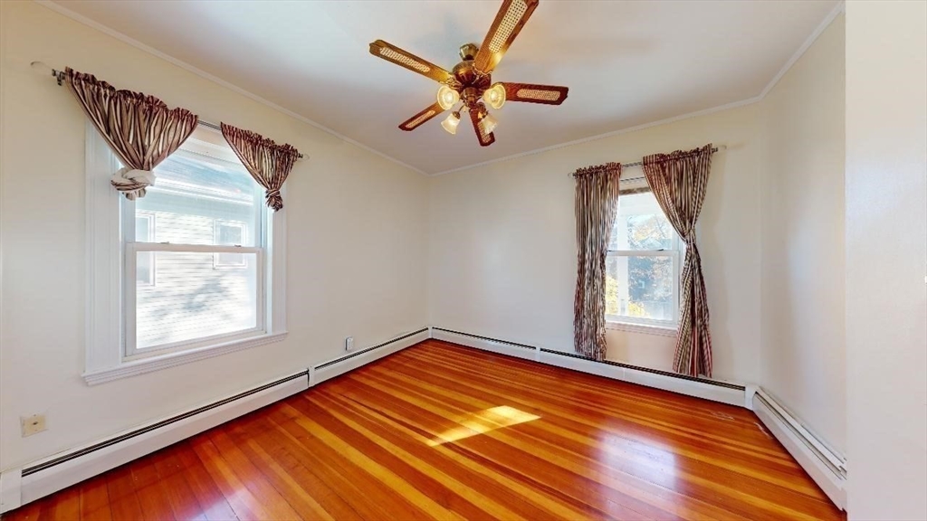 17 Gorham Road, Unit 2 Medford, MA 02155 - Photo 16 of 37 an empty room with windows and ceiling fan