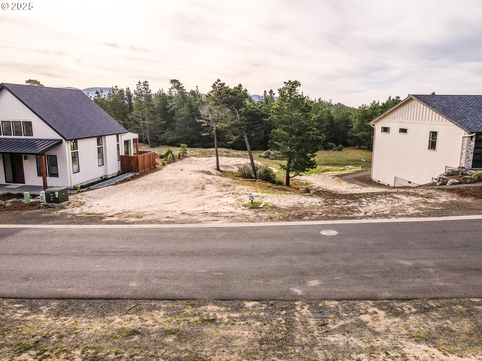 456 Meadows Drive, Unit 78 Nehalem, OR 97131 - Photo 2 of 21 a view of a house with a snow on the road and a building