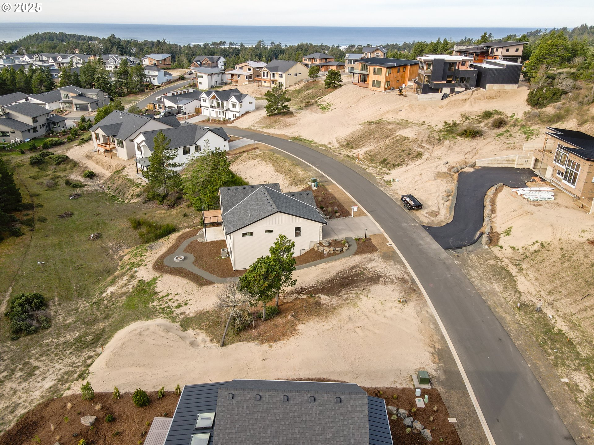 456 Meadows Drive, Unit 78 Nehalem, OR 97131 - Photo 7 of 21 an aerial view of lake and residential houses with outdoor space