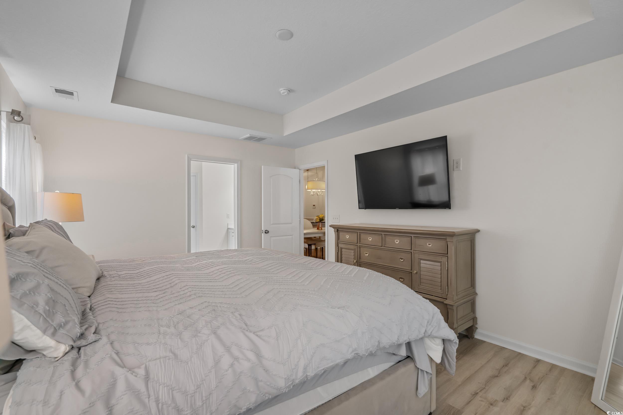 733 Old Castle Loop Myrtle Beach, SC 29579 - Photo 20 of 39 Bedroom featuring a tray ceiling and light wood-st