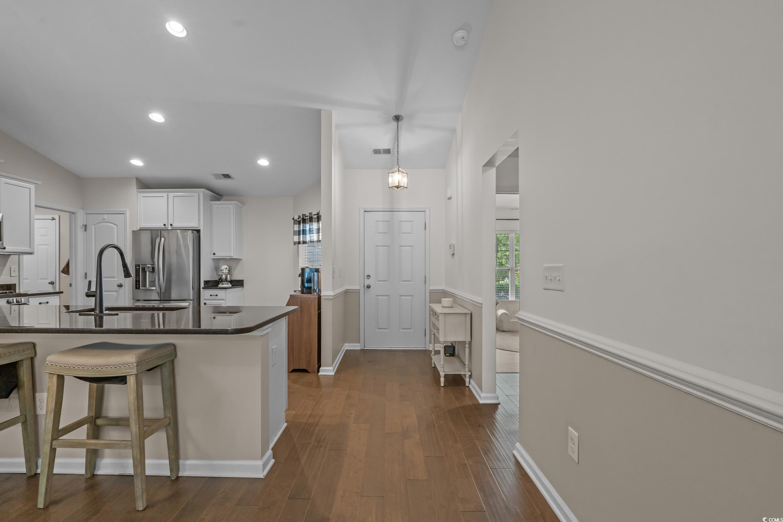 733 Old Castle Loop Myrtle Beach, SC 29579 - Photo 4 of 39 Kitchen with dark countertops, white cabinetry, da