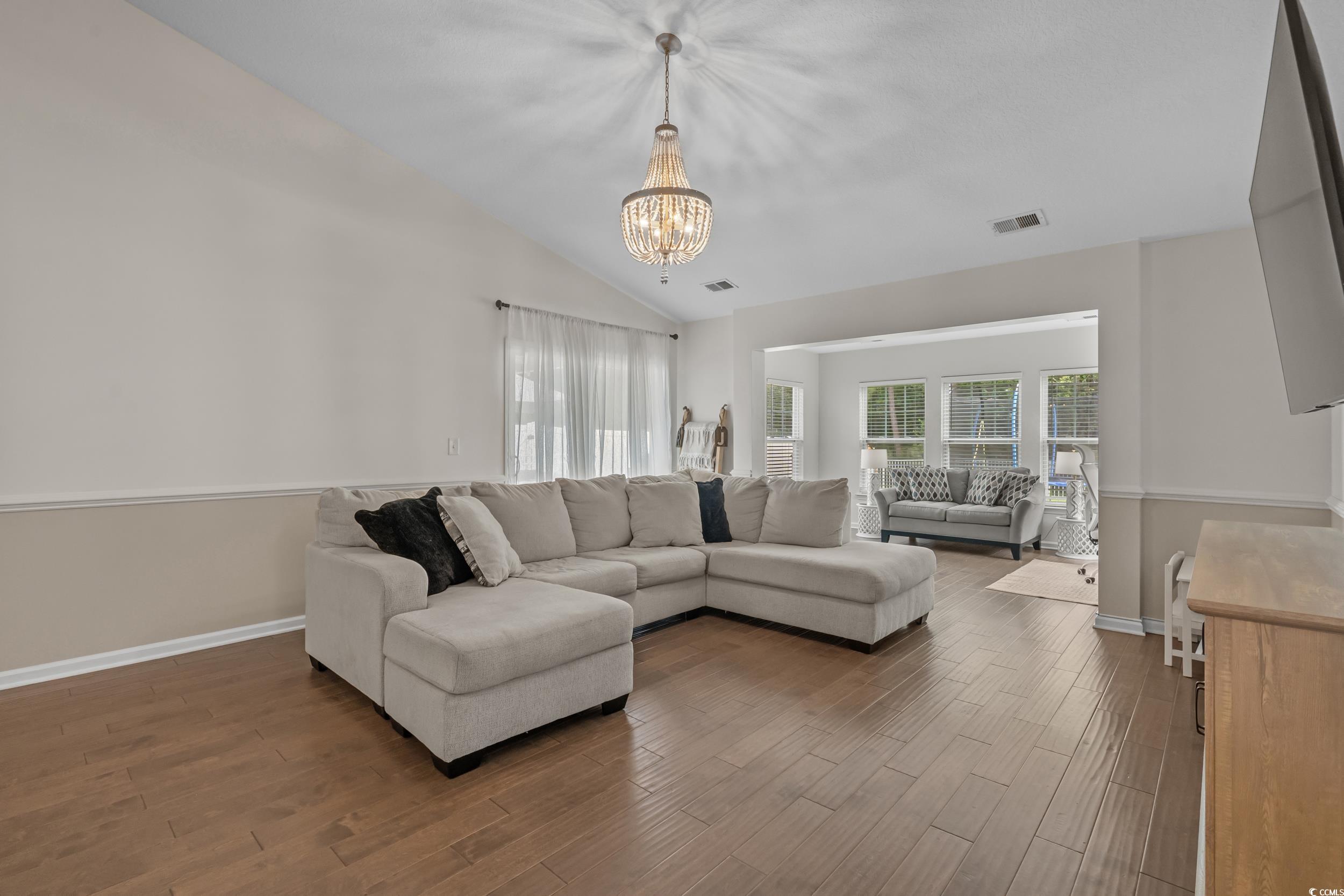 733 Old Castle Loop Myrtle Beach, SC 29579 - Photo 7 of 39 Living room featuring a chandelier, wood finished