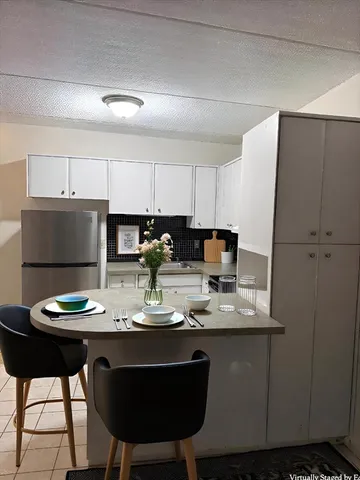 a kitchen with a dining table and chairs