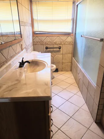 a bathroom with a sink and a large window