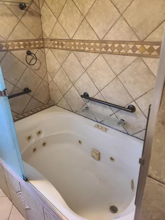 a bathroom with a bathtub and shower