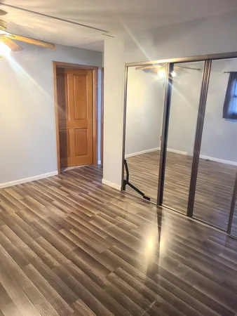 a view of hallway with wooden floor