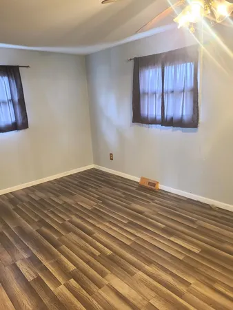 a view of a room with wooden floor and cabinet