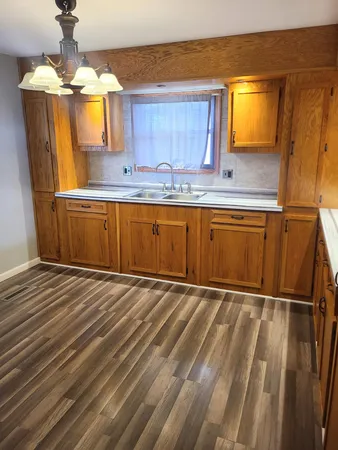 a kitchen with granite countertop a sink and cabinets