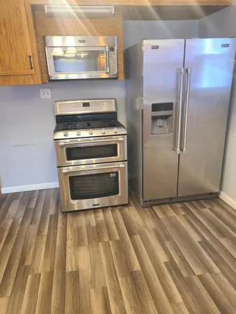 a kitchen with a stove and a refrigerator