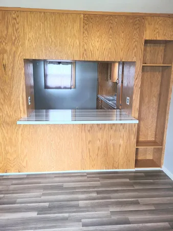 a view of a kitchen with a sink and a window