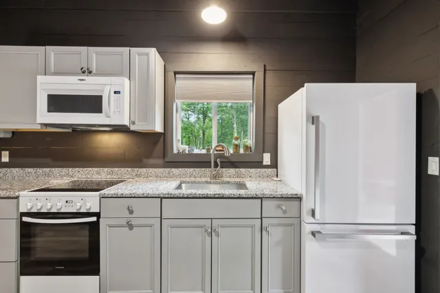 a bathroom with a toilet a sink a vanity and mirror