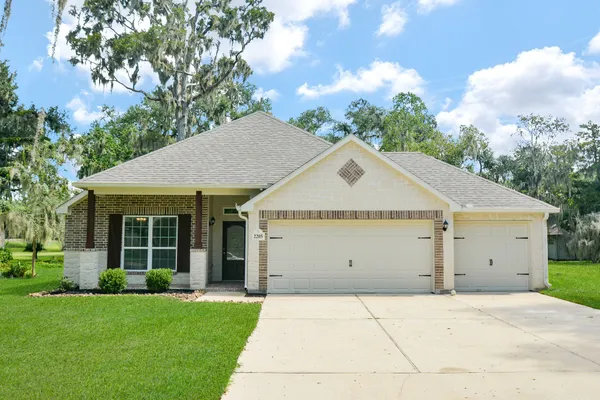 a view of a house with a yard and garage