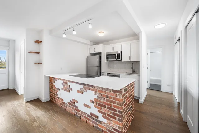 a kitchen with stainless steel appliances granite countertop a sink stove and microwave