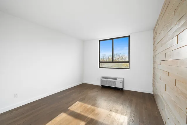 a view of an empty room and wooden floor