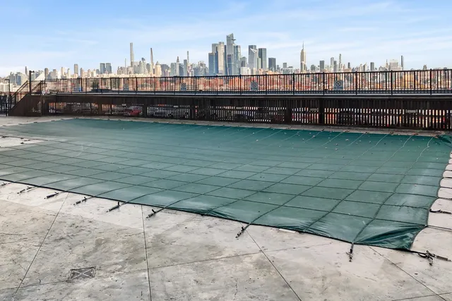 a living room with furniture kitchen view and a large window