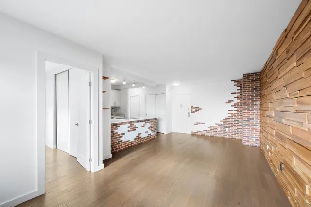a view of a livingroom with wooden floor and a window