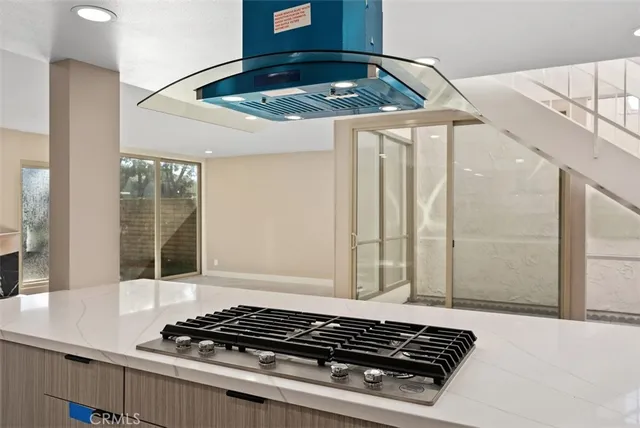 a view of an empty room with a fireplace and a window