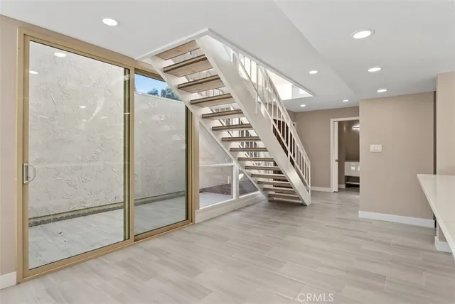 an empty room with wooden floor and door