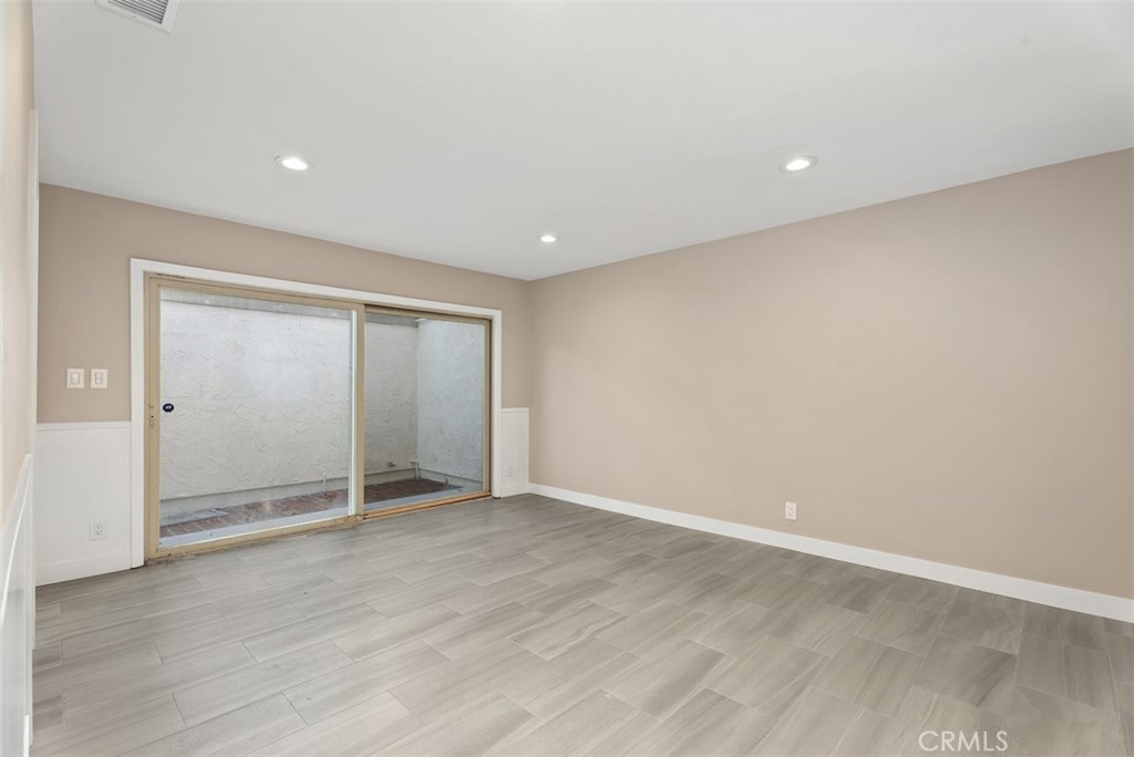 54 Oak Tree Lane Irvine, CA 92612 - Photo 17 of 40 an empty room with wooden floor and door