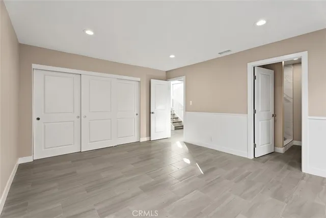 a bathroom with a granite countertop sink toilet and a mirror