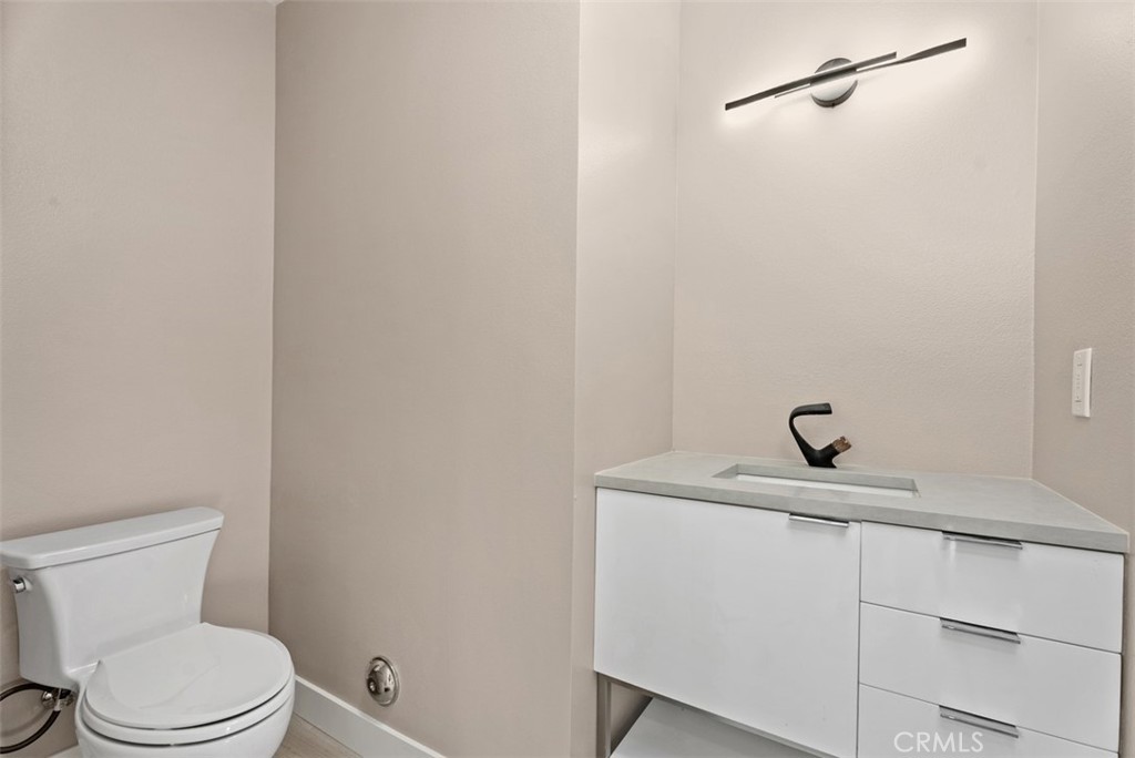 54 Oak Tree Lane Irvine, CA 92612 - Photo 21 of 40 a bathroom with a toilet sink and vanity