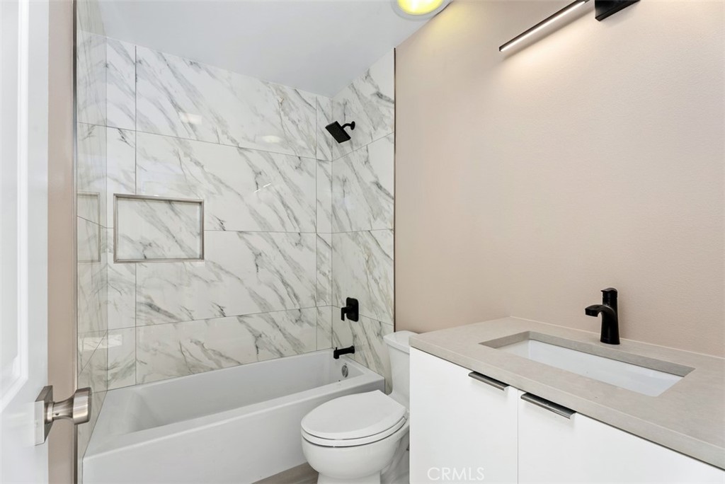 54 Oak Tree Lane Irvine, CA 92612 - Photo 23 of 40 a bathroom with a sink a toilet and a bathtub