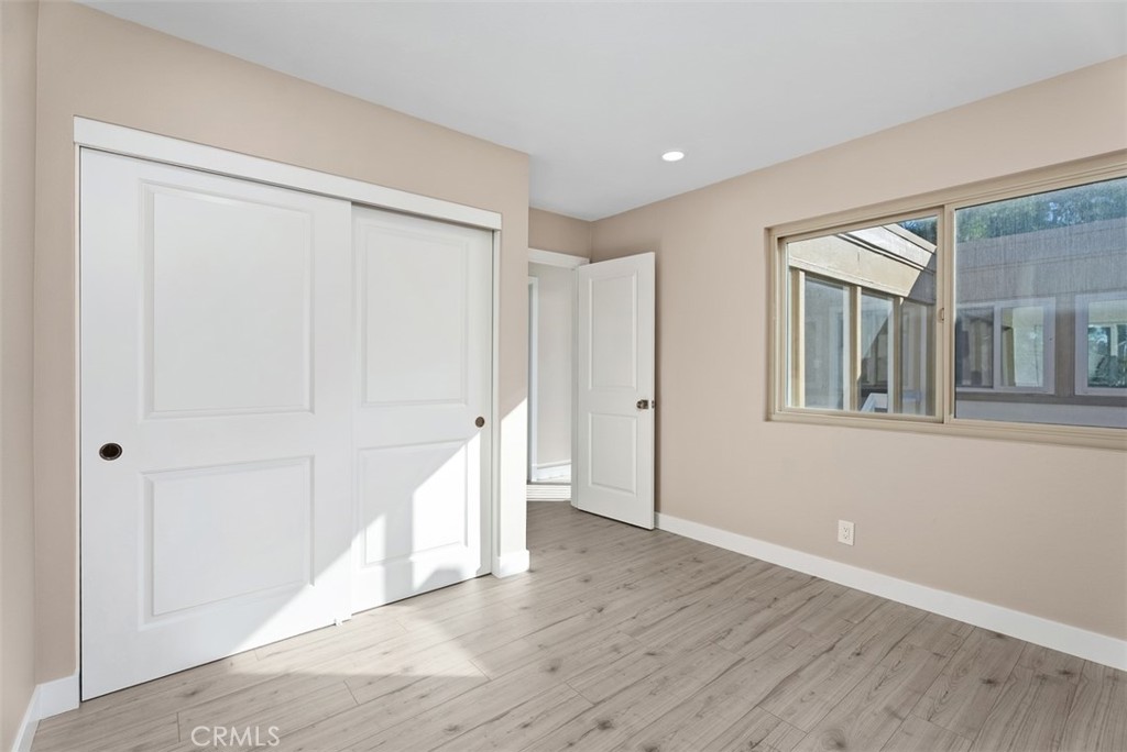 54 Oak Tree Lane Irvine, CA 92612 - Photo 25 of 40 a view of an empty room with wooden floor and stairs