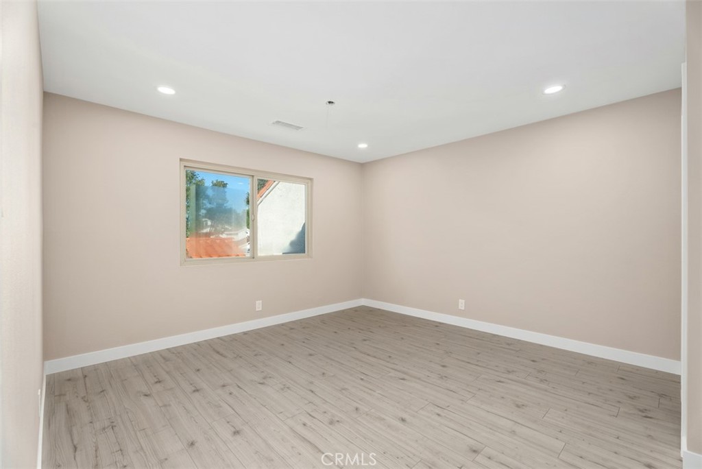 54 Oak Tree Lane Irvine, CA 92612 - Photo 27 of 40 an empty room with wooden floor and window