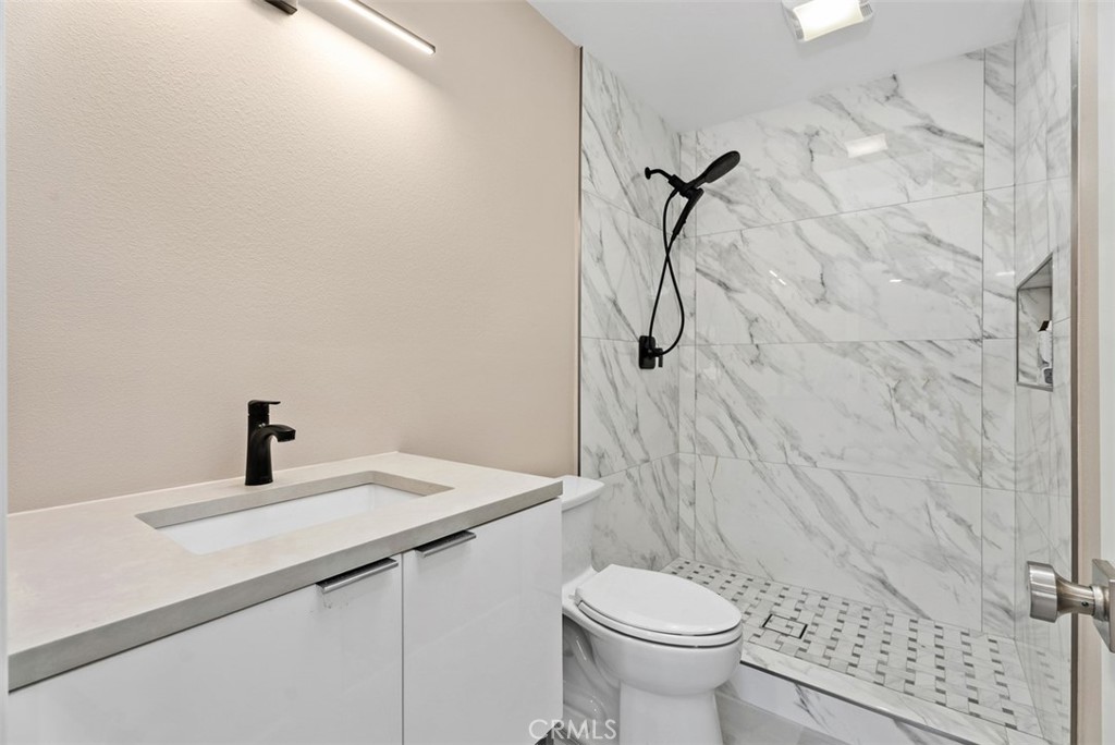 54 Oak Tree Lane Irvine, CA 92612 - Photo 29 of 40 a bathroom with a sink a toilet and shower