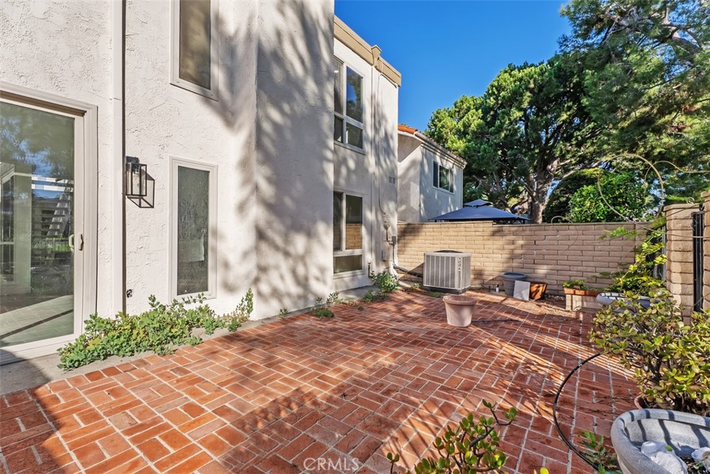 54 Oak Tree Lane Irvine, CA 92612 - Photo 37 of 40 a view of a patio with a table and chairs under an umbrella