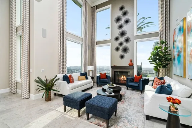 a living room with furniture a flat screen tv and a large window