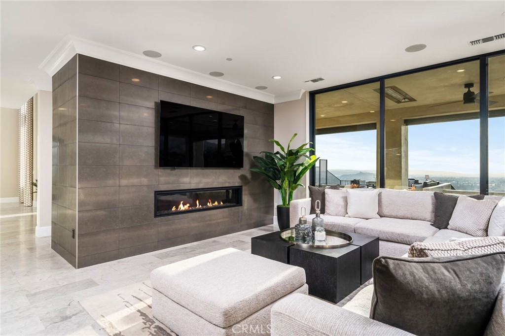4485 Broken Spur Road La Verne, CA 91750 - Photo 17 of 75 a living room with furniture a flat screen tv and a large window