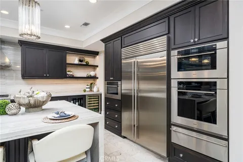 a kitchen with stainless steel appliances a sink stove and cabinets