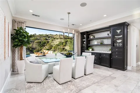 a spacious bathroom with a double vanity sink a large mirror and a bathtub